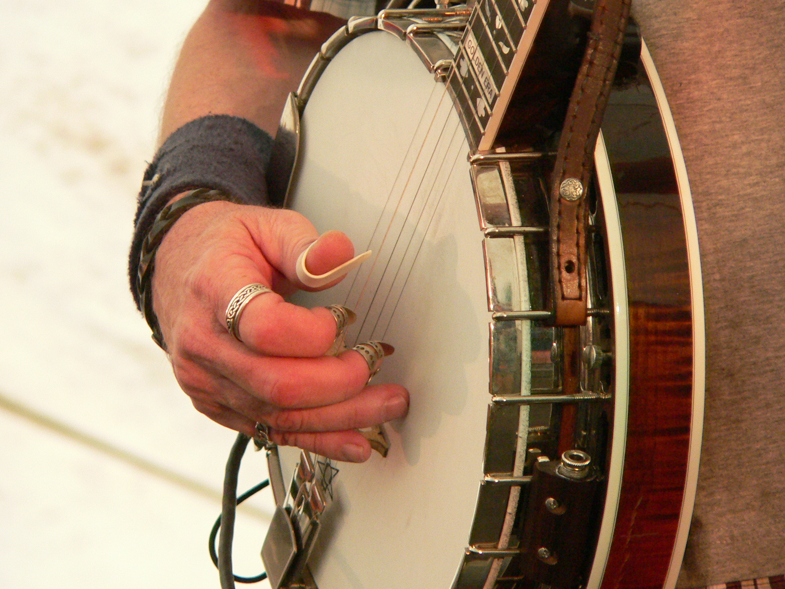 Don Wayne Reno wearing finger picks while playing a banjo