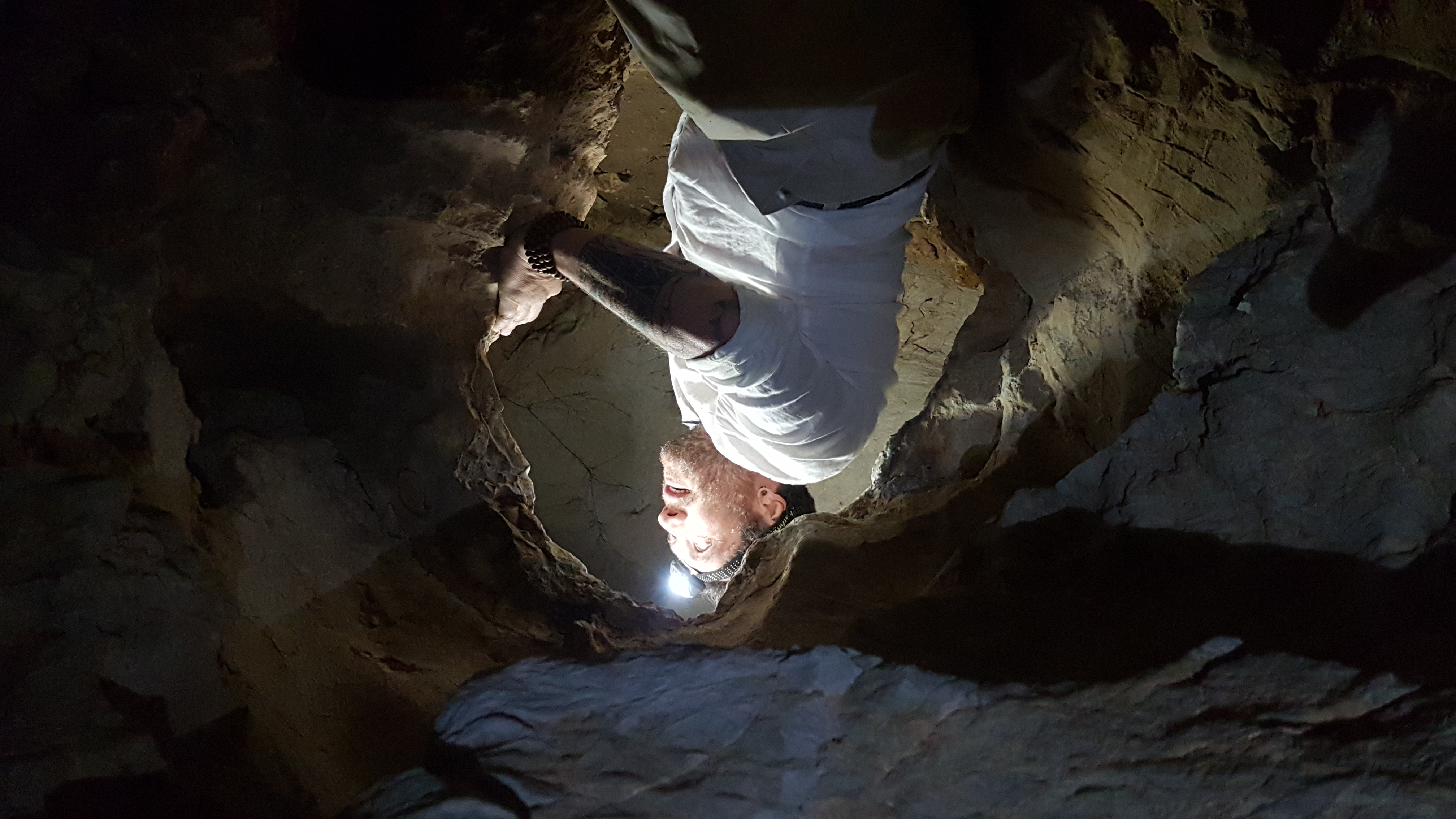 Professor Renaud Joannes-Boyau admiring the inside of a cave containing fossil remains of past species.