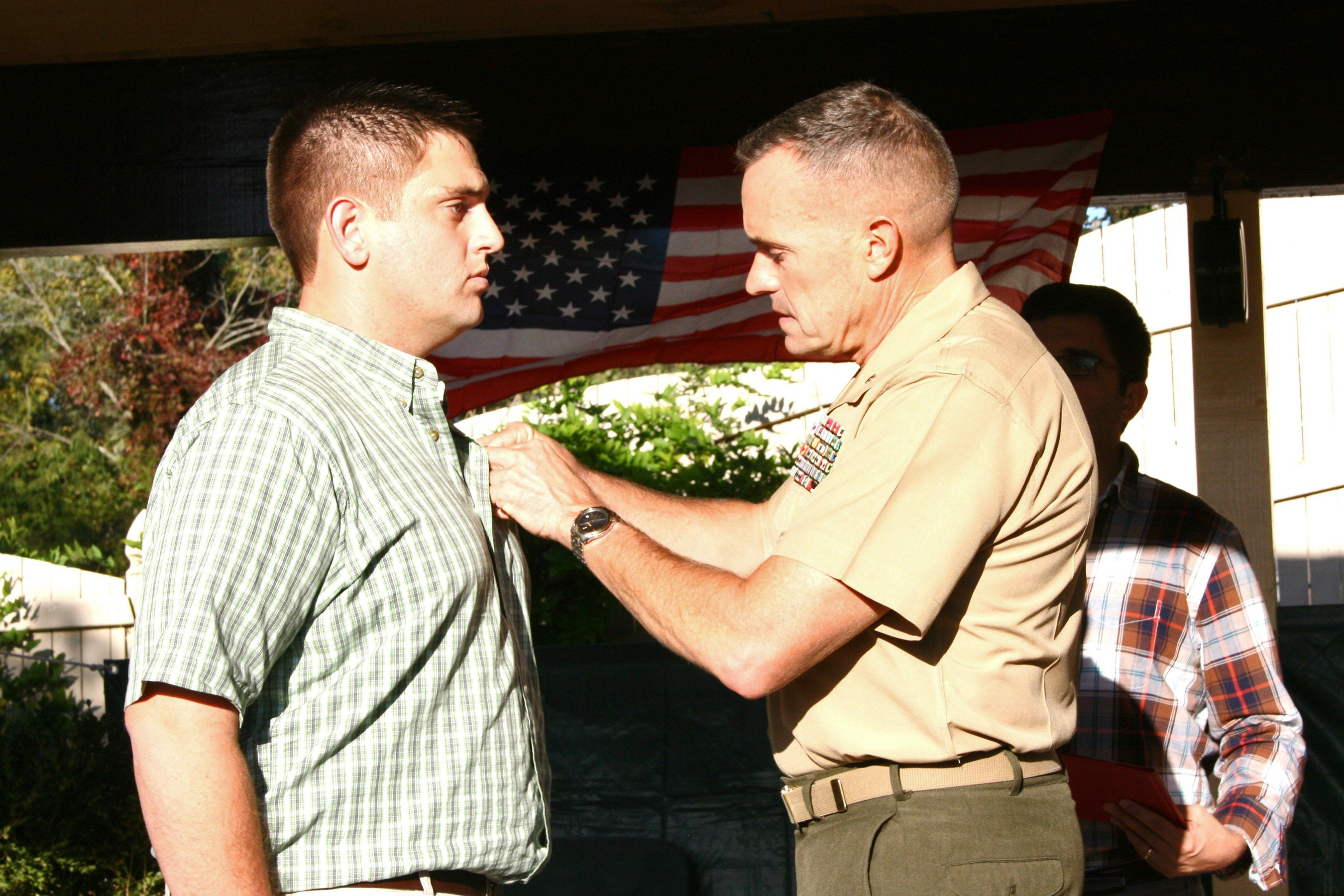Pinning a Purple Heart on his son, Ferdinand Coglianese