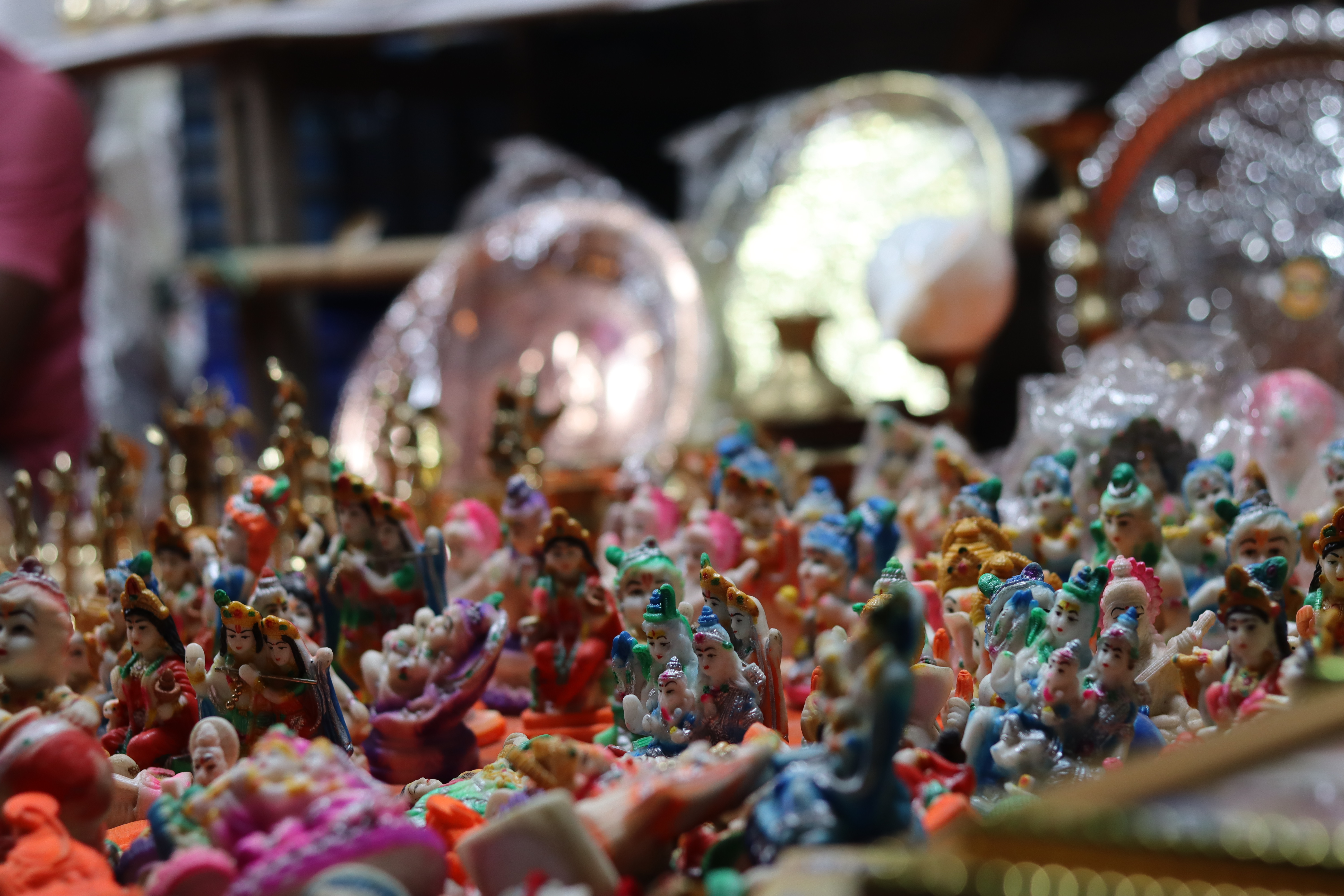 A collection of miniature Hindu deities displayed for worship and devotion at a village fair in Ramgarh Upazila, Khagrachhari Hill District
