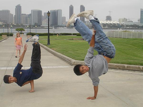 San Diego Bboy-Shun and Bboy-Ronick, one performing an airchair(left) and one performing a pike(right)