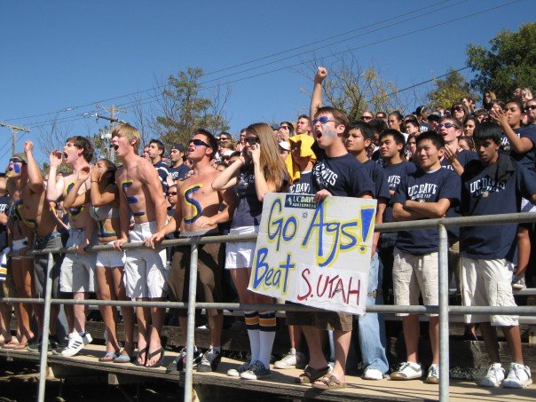 Fans of the Aggie Pack participating in a cheer.