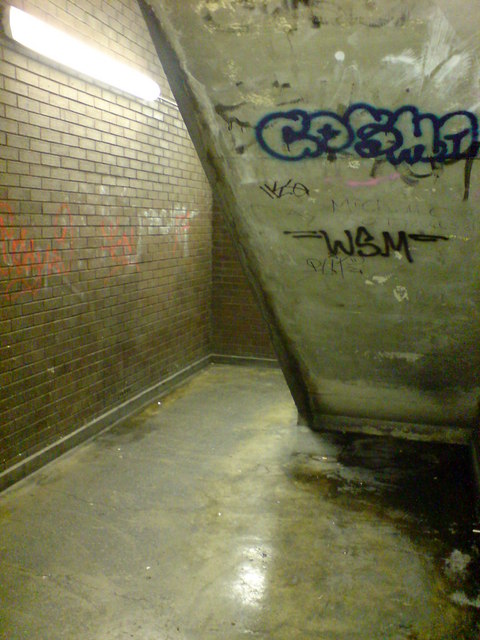 Back stairwell of the Market Hall multistorey car park, 2008; concrete walls covered in graffiti, urine stains, and signs of urban deprivation.