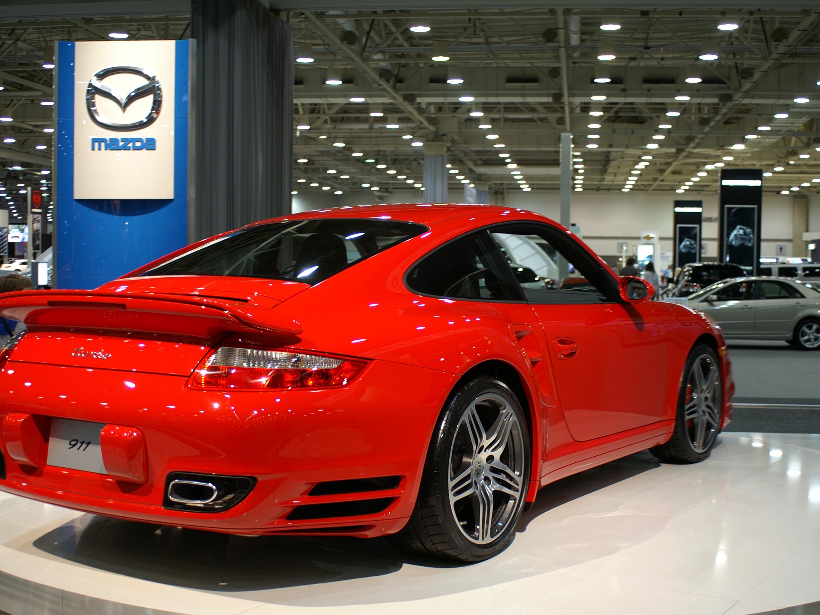 The red Porsche 911 was driven out of the showroom glass doors