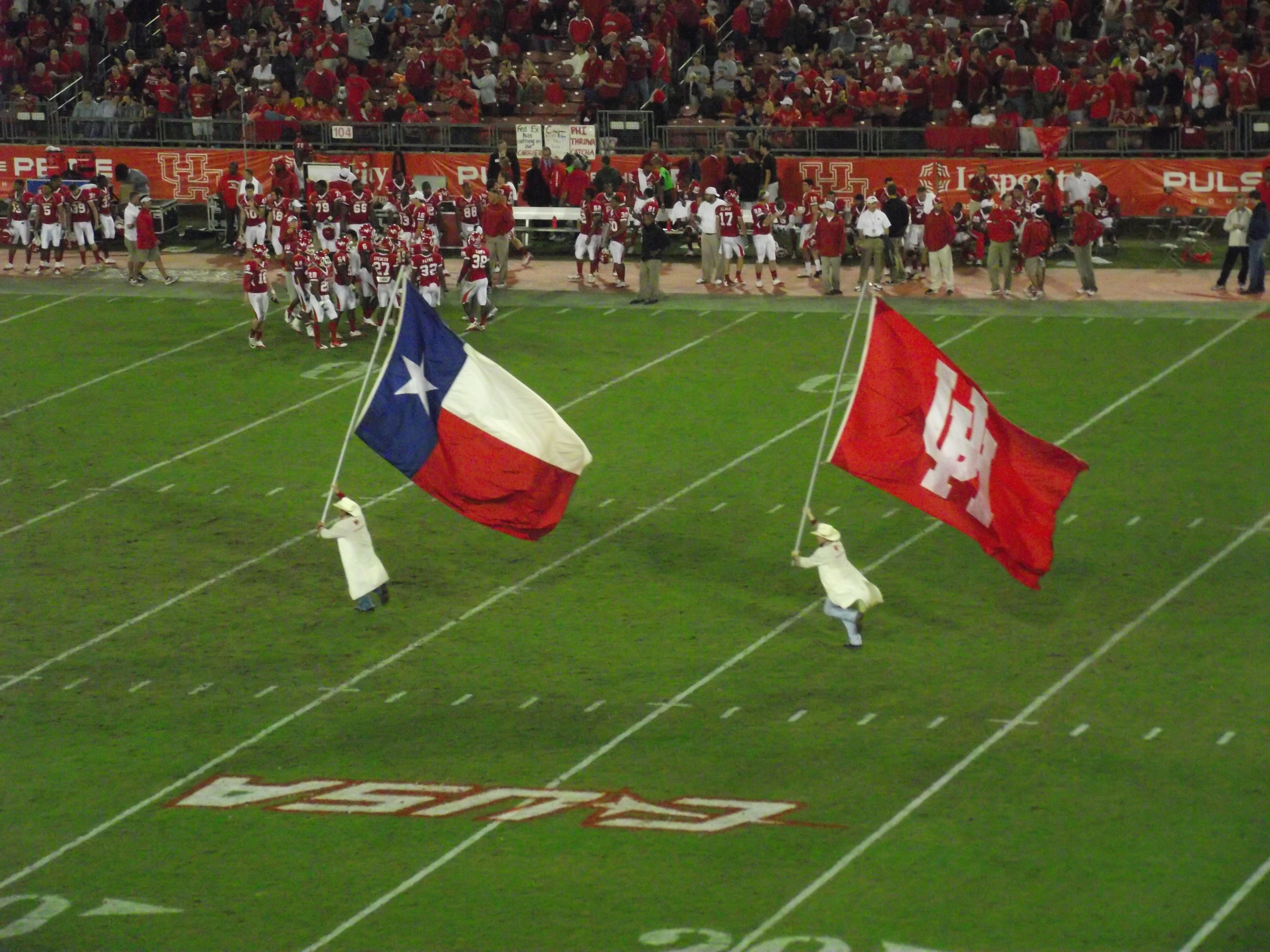The Frontiersmen running across the field after a Cougars touchdown at Robertson Stadium