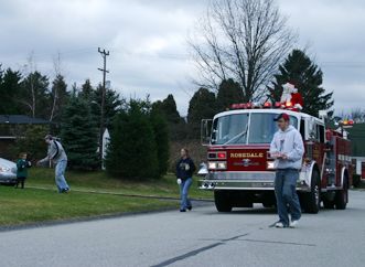 Firefighters Helping Santa Visit the Community