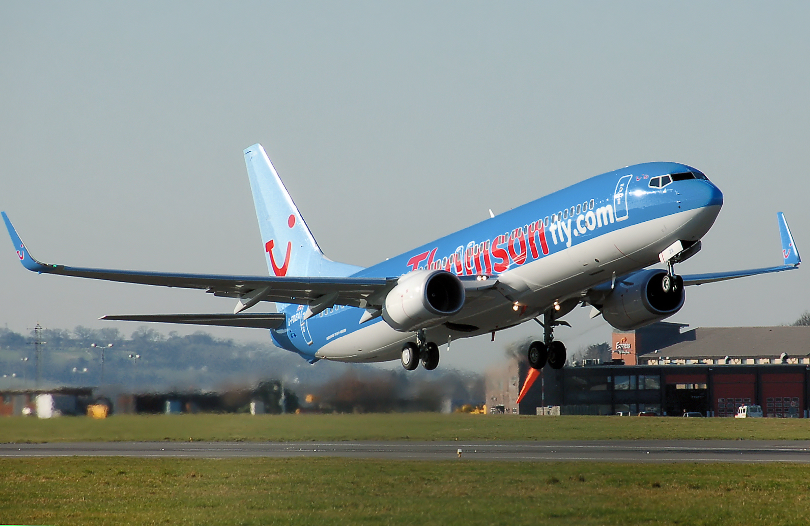 Thomsonfly Boeing 737-800 takes off from London Luton Airport, England. (2007)