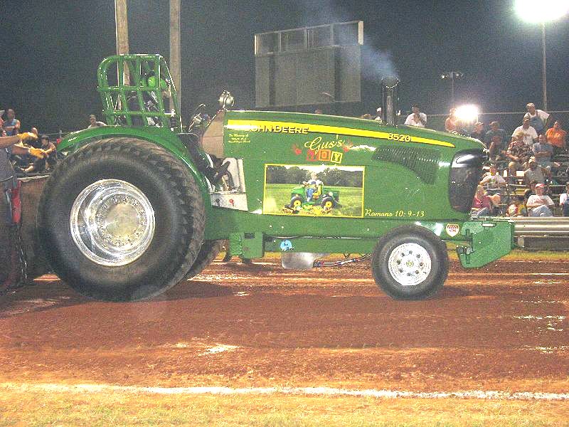 A John Deere pulling tractor.