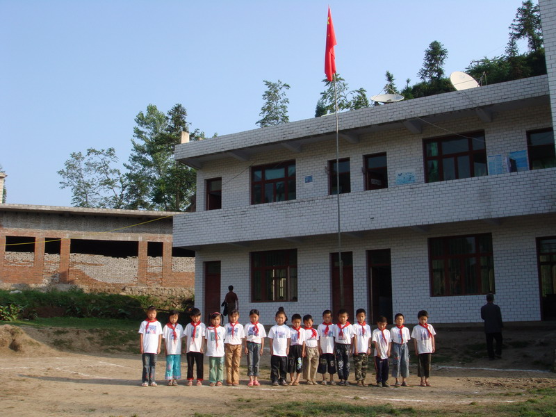 Grade 3 students in front of the school