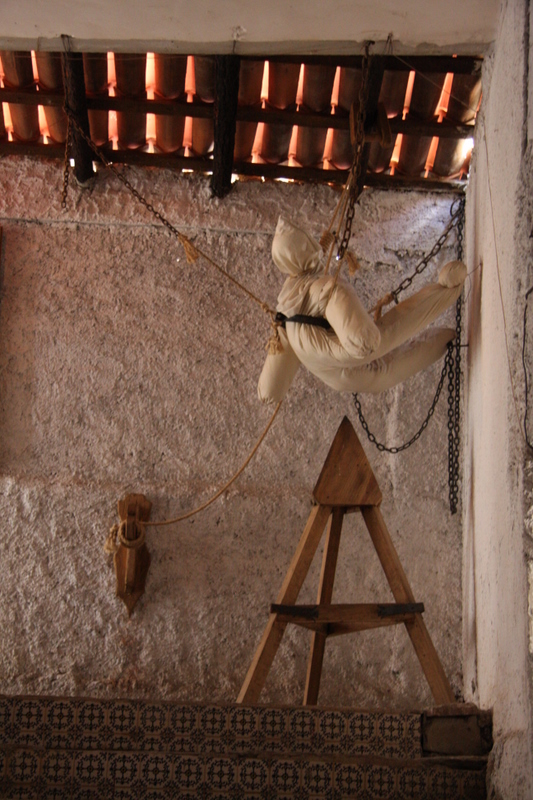 A dummy lowered onto a Judas Cradle