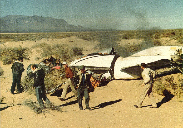 NRL scientists J. D. Purcell, C. Y. Johnson, and Dr. F. S. Johnson among those recovering instruments from a V-2 used for upper atmospheric research above the New Mexico desert. This is V-2 number 54, launched January 18, 1951 (photo by Dr. Richard Tousey, NRL).