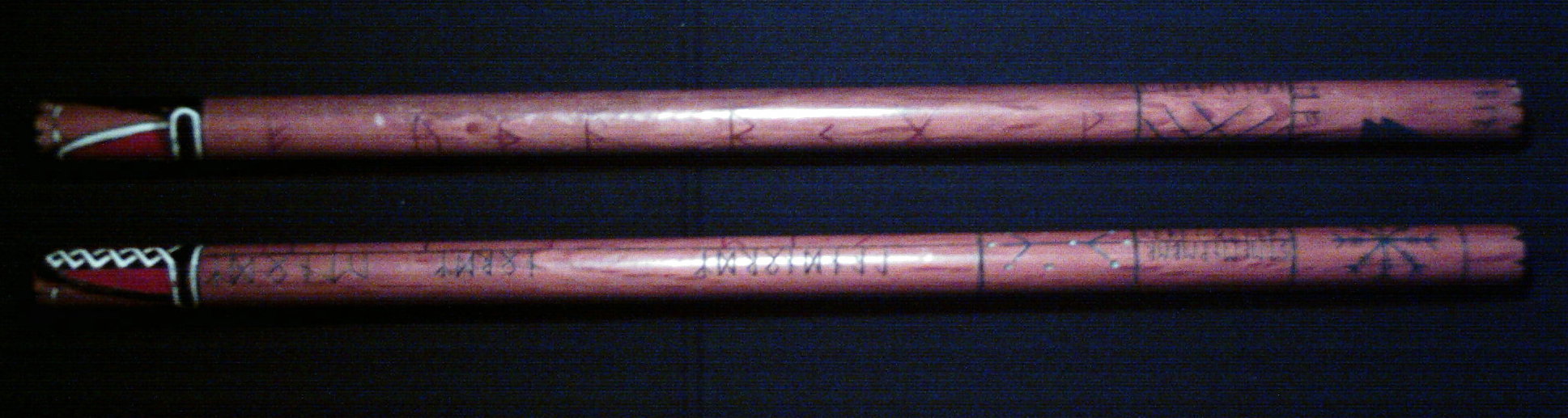 Traditional Weaponry: Single ringed stick above & double ringed stick underneath showing runes and pictographs with traditional structural layout Traditional Weaponry: Single ringed stick above & double ringed stick underneath showing runes and pictographs with traditional structural layout