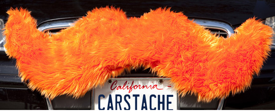 Carstache mounted on top of the grille of an Audi.