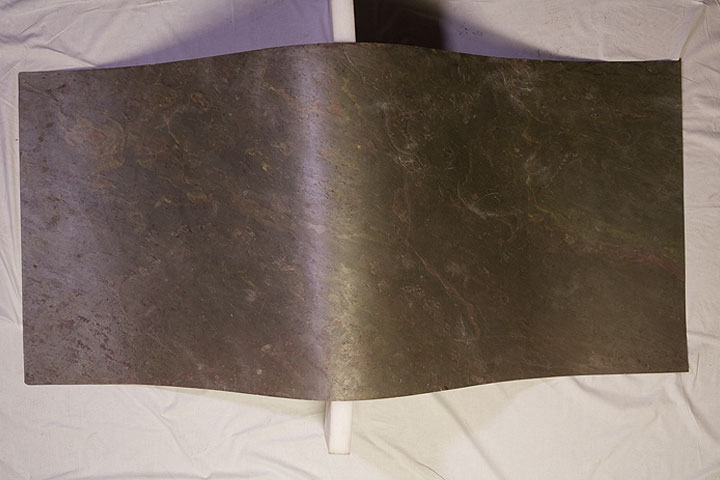 A sheet of flexible stone veneer illustrating its flexible nature A sheet of flexible stone veneer illustrating its flexible nature