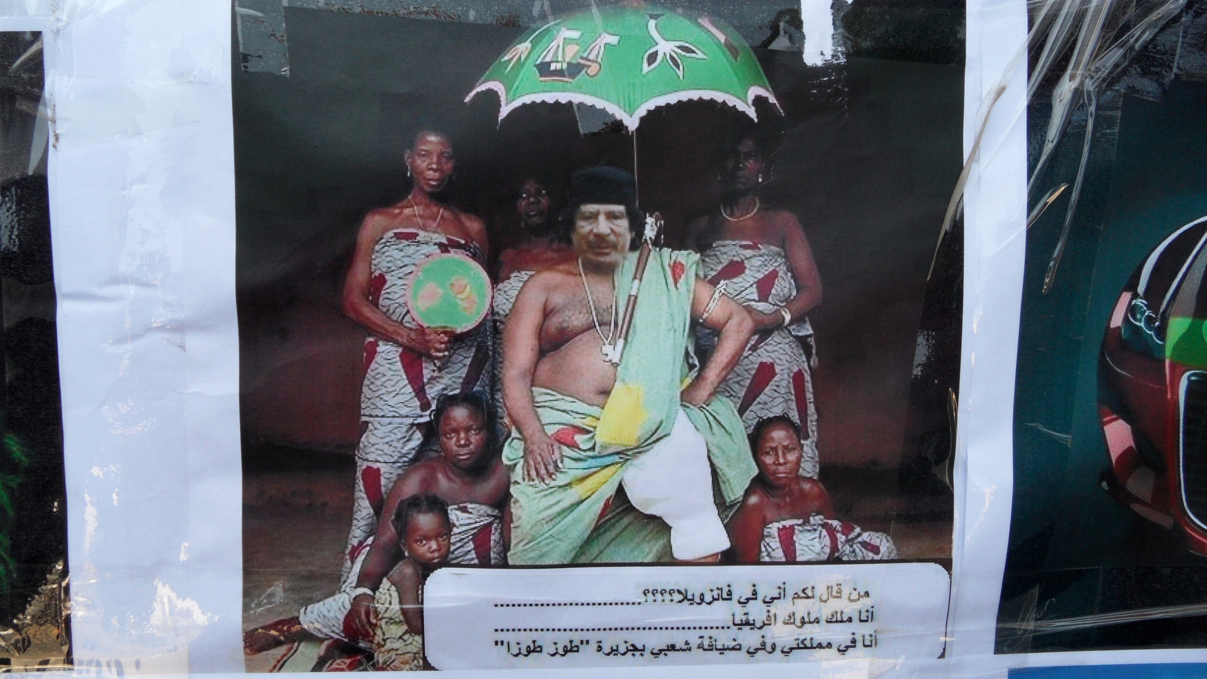 A manipulated photo ridiculing Gaddafi hangs in a store in Tripoli