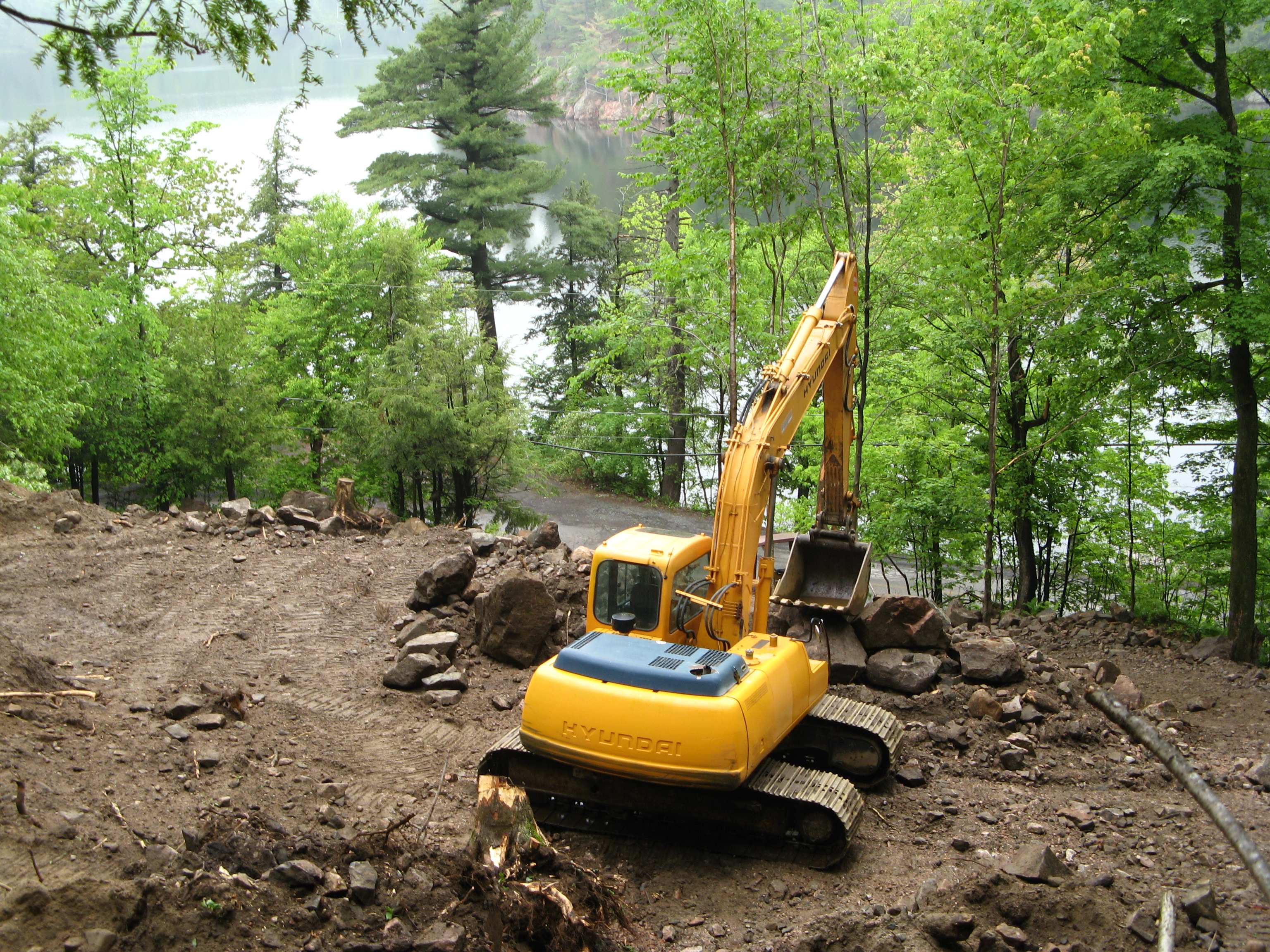 A hillside is ripped apart to make way for new housing at Meech Lake|NCC allows shoreline construction at Meech Lake.