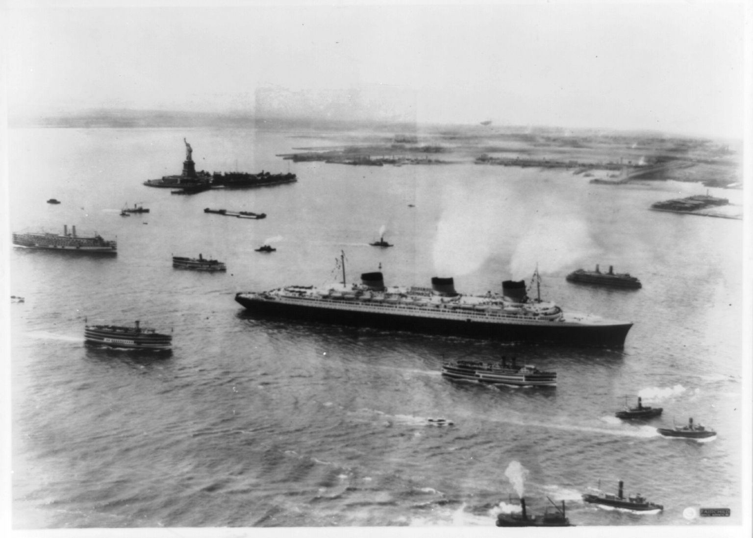 The SS Normandie arriving in New York Harbor on maiden voyage escorted by several tugboats. The SS Normandie arriving in New York Harbor on maiden voyage escorted by several tugboats.