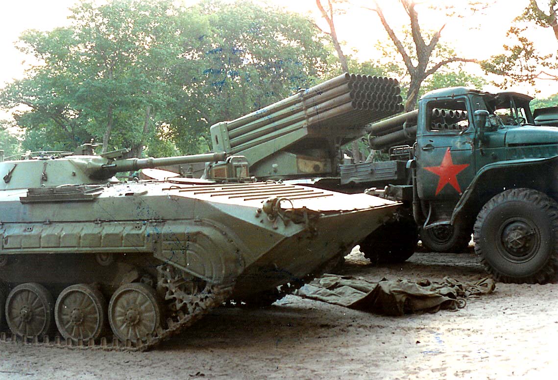Decommissioned UNITA BMP-1 and BM-21 Grads at an assembly point.
