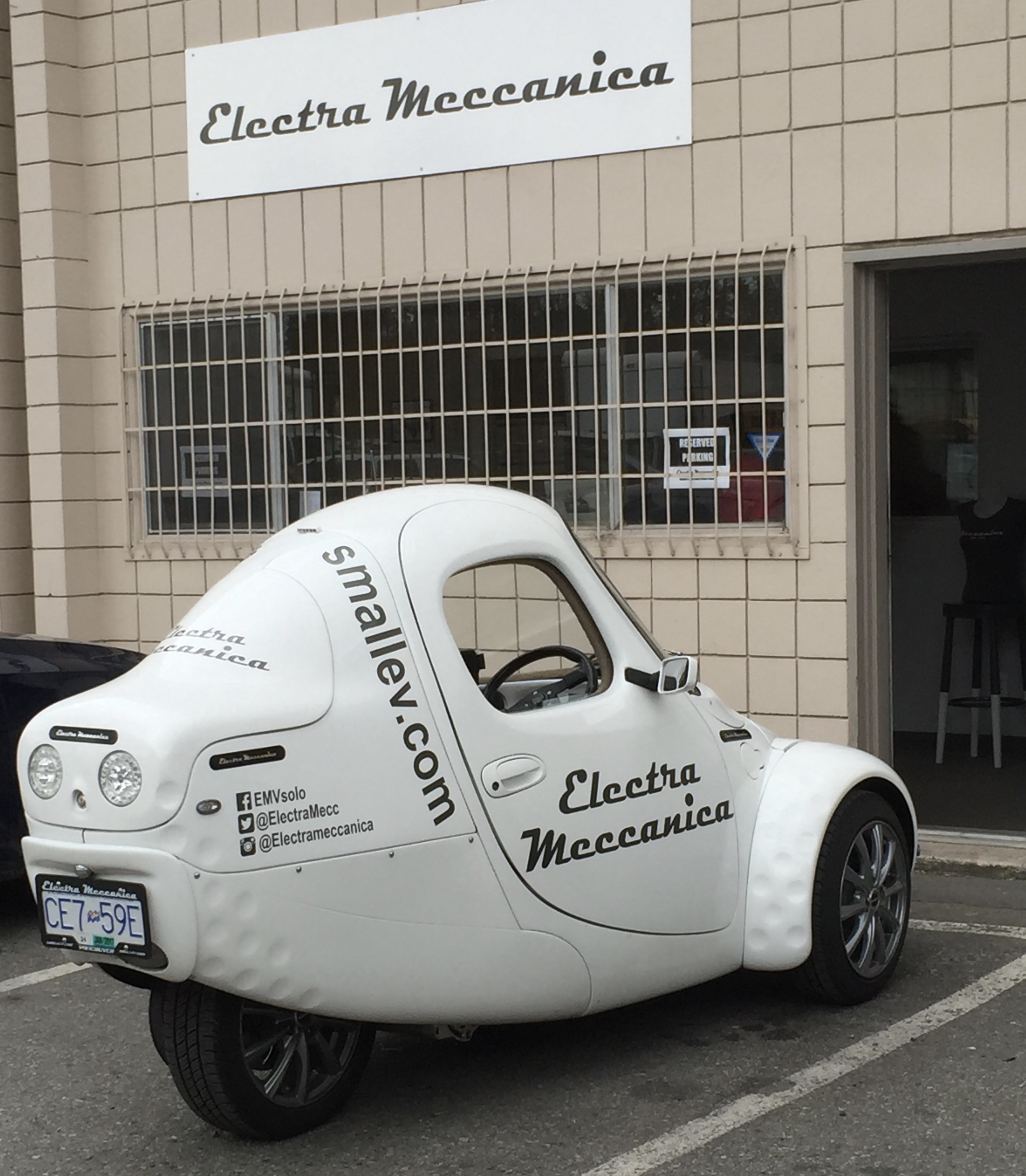 Three-wheeler Sparrow car in front of New Westminster facility in 2016