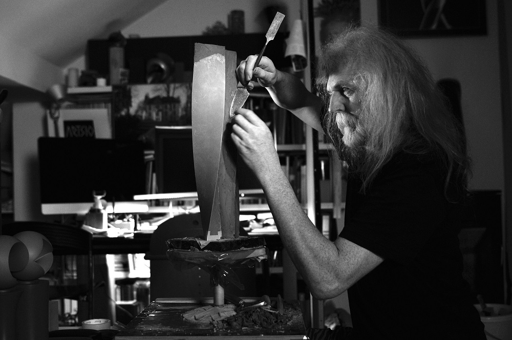 Mr. Vlastimil Beránek working at model of new sculpture.