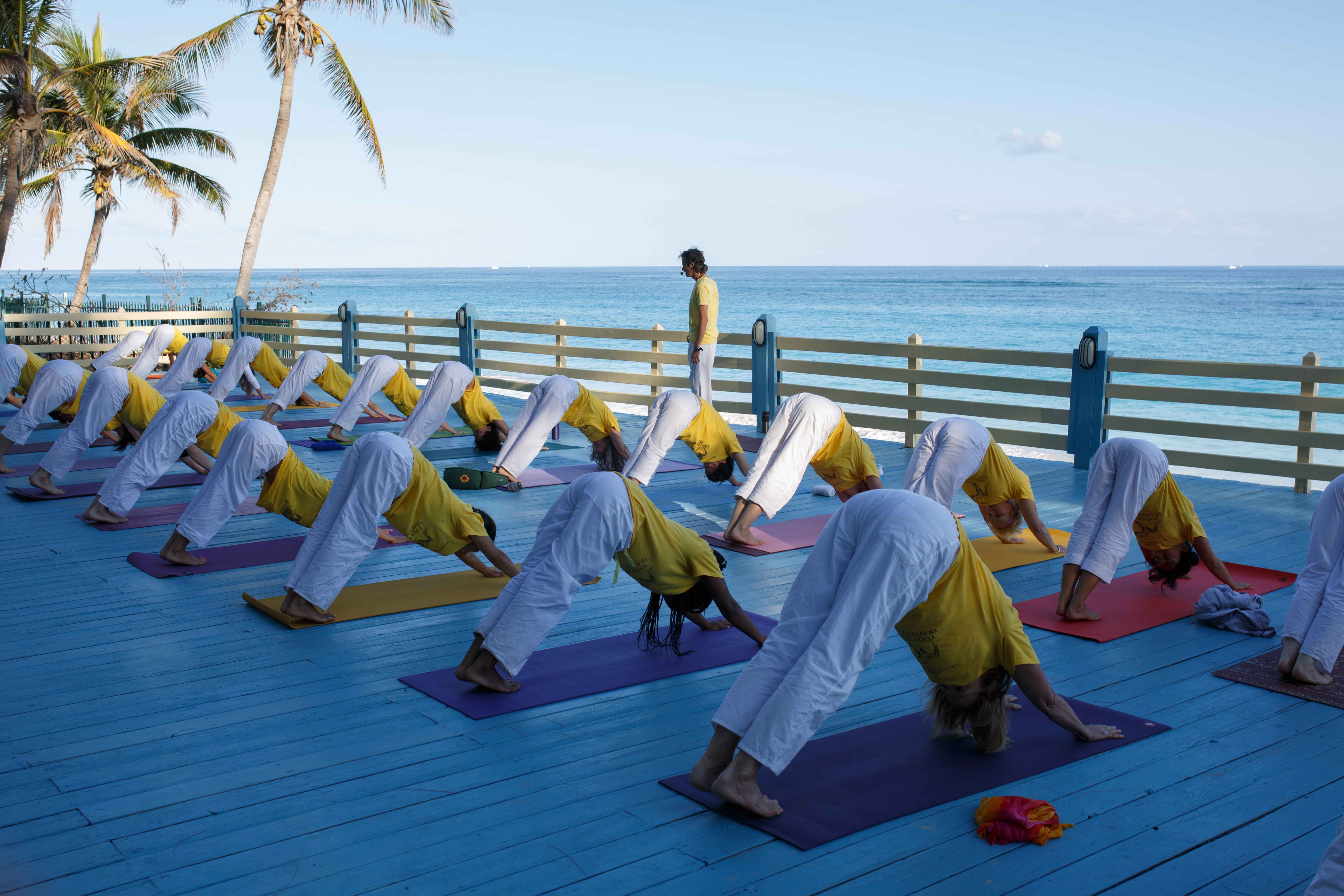 Yoga Teacher Training Course students practicing Hatha Yoga on the Beach Platform