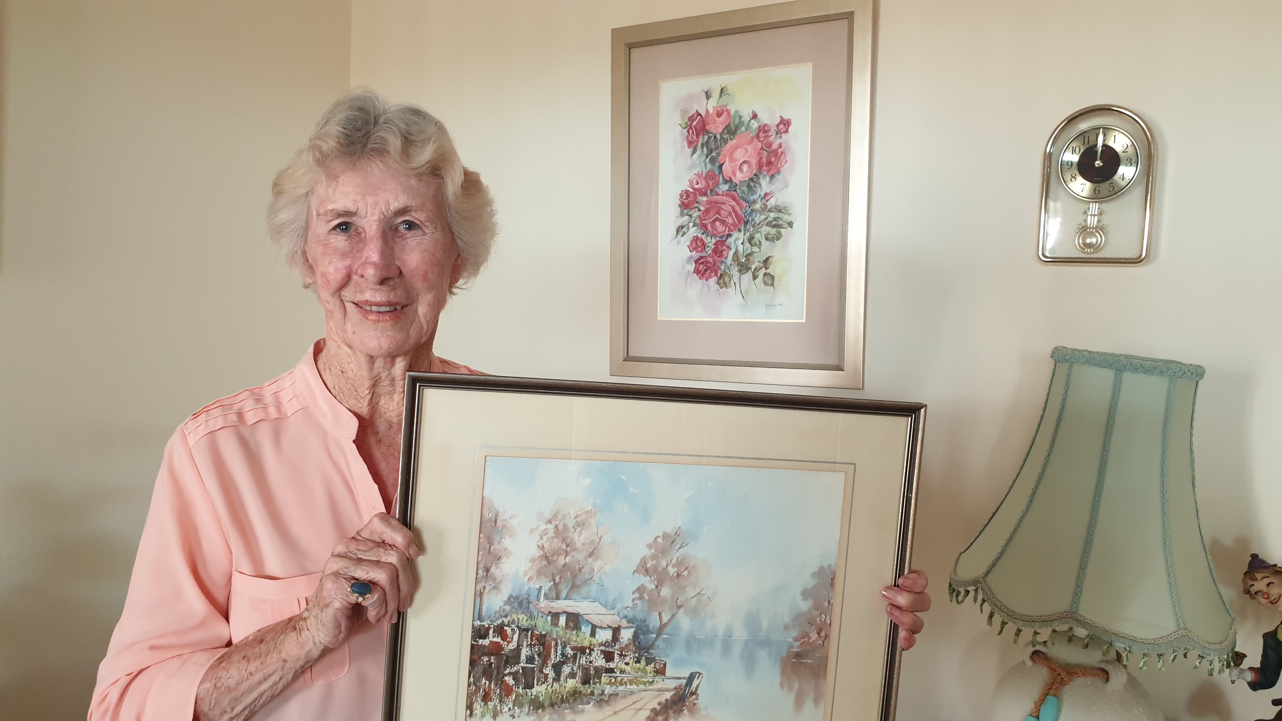 Artist May O'Neill holds one of her works|right