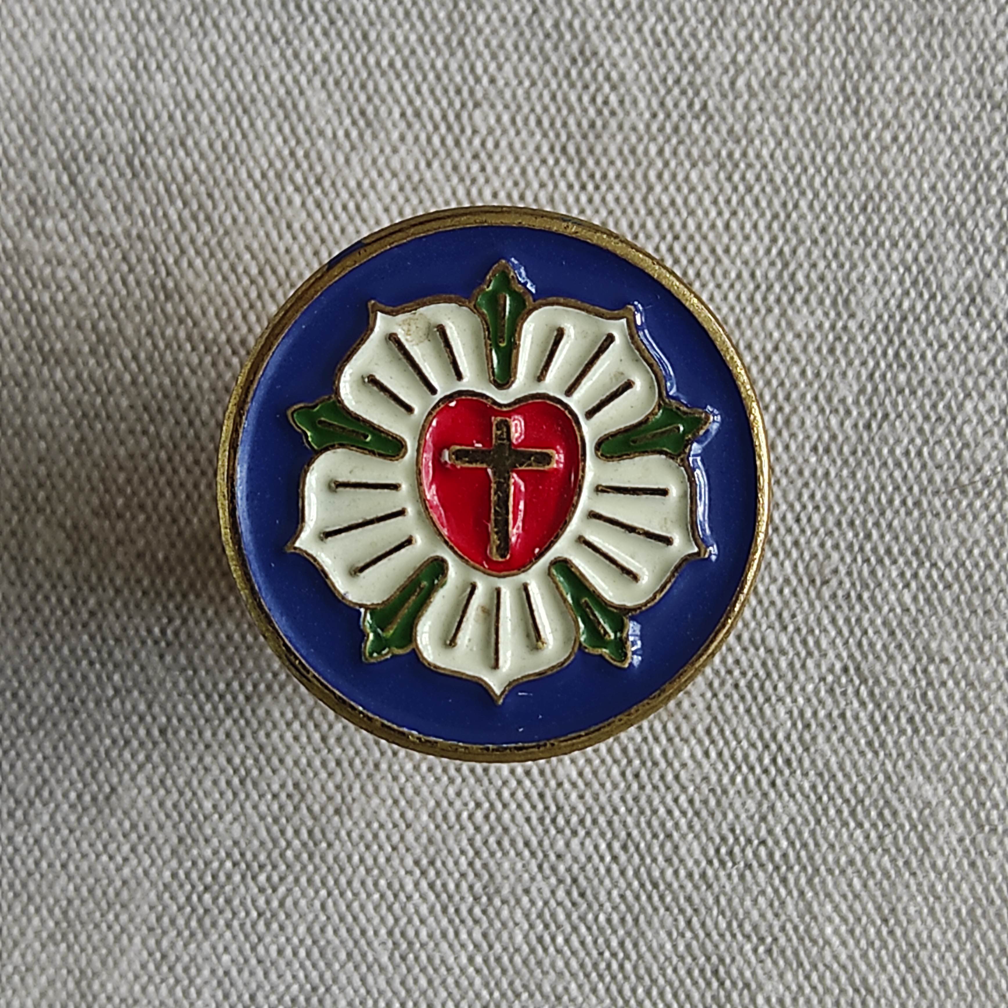 One notable exhibit is the Luther Rose, a symbol of Lutheranism and the typical seal of the Evangelical Church of the Augsburg Confession in Poland. This emblem, created in 1997, measures 15 × 15 mm.