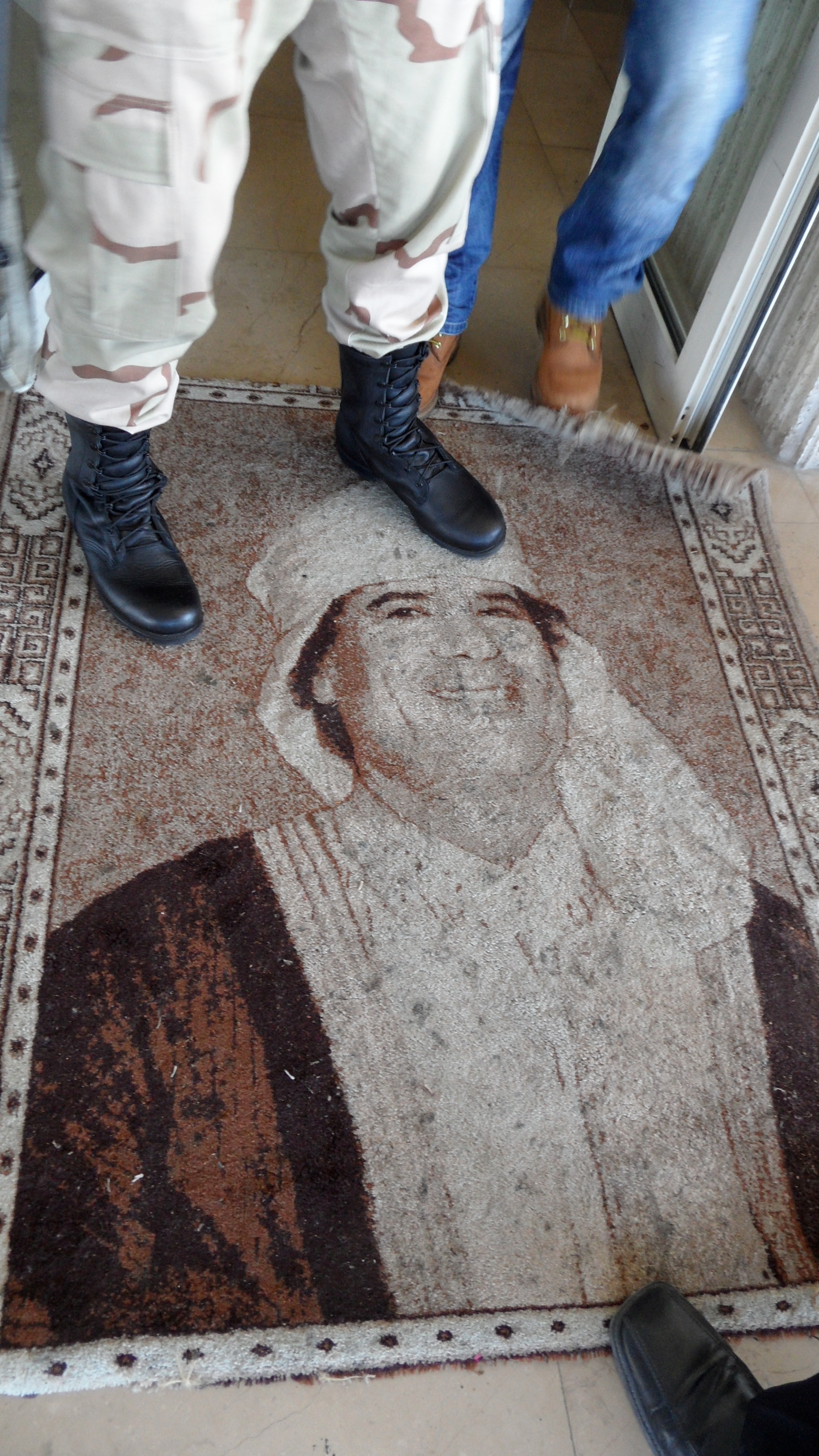  thumb|A Libyan soldier stands on the image of Gaddafi in a Tripoli hotel