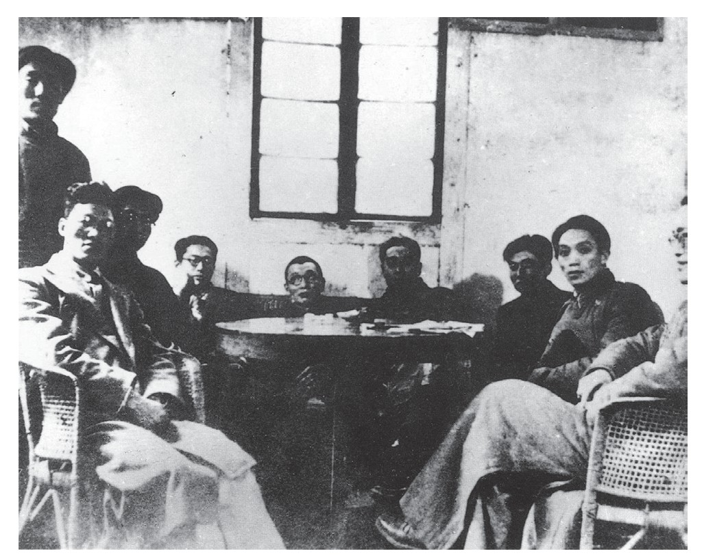 Group photograph of the Xinhua Daily staff in 1944. Seated from left to right: Xu Dixin, Ge Baoquan, Hua Gang, Pan Zinian, Zhou Enlai, Chen Jiakang, Xue Zizheng, and Hu Sheng|thumb|230px