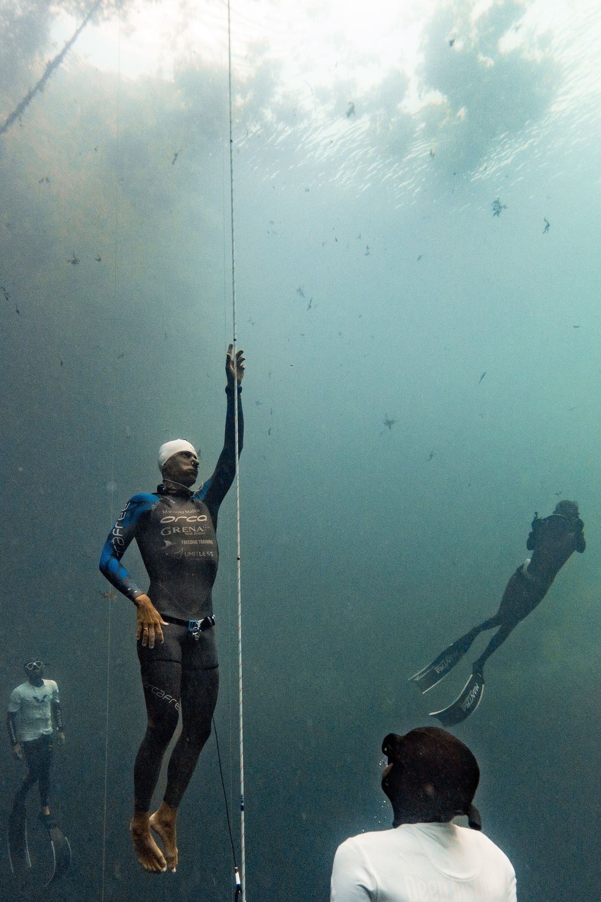 A freediver ascending from a deep free immersion dive. Falling ambient pressure during ascent causes pulmonary gas to expand while alveolar and arterial oxygen partial pressure can decline rapidly.
