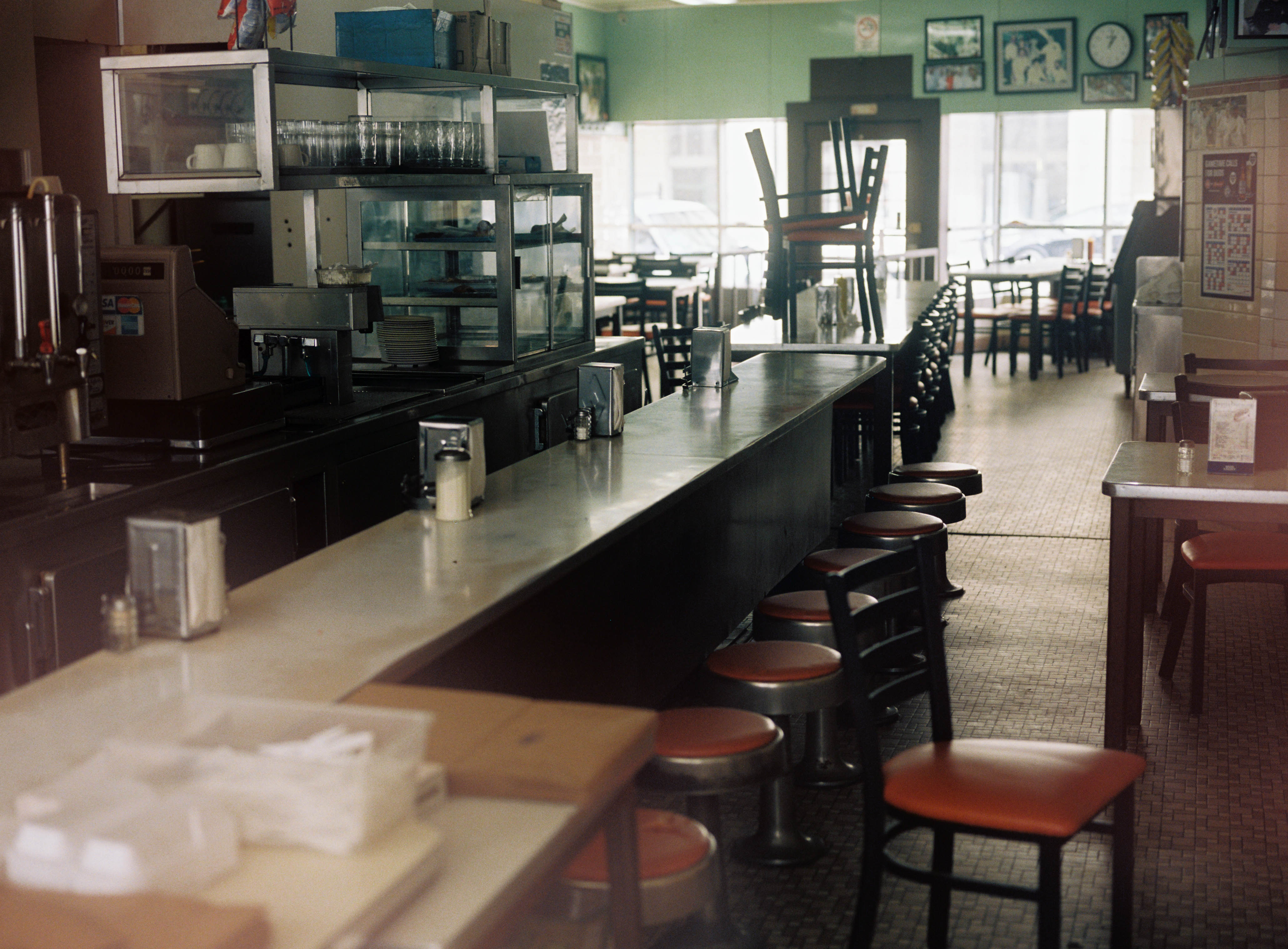 The contrasting green interior of Lafayette Coney Island, with its long lunch counter