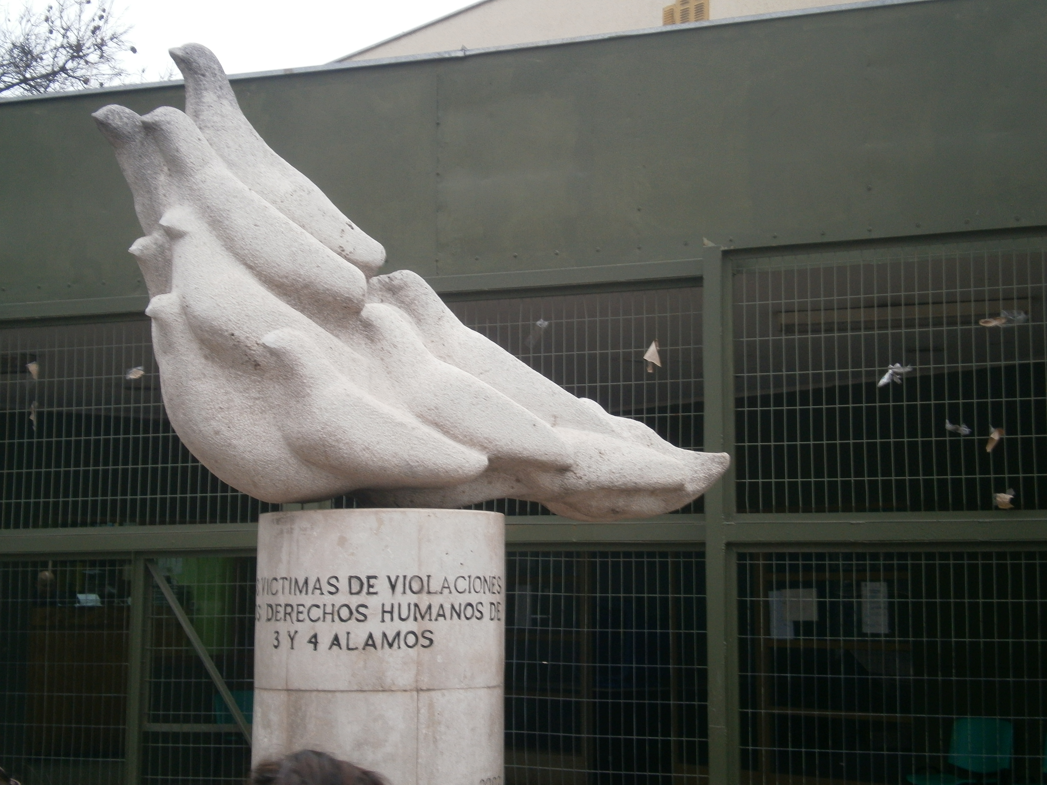 Memorial outside the former compound, dedicated to its victims