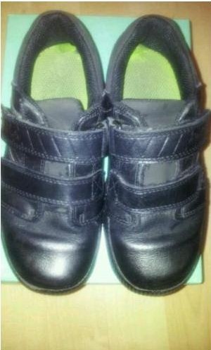 A used pair of Jack Nano shoes, previously worn by a 7 year old boy for school shoes. This picture shoes the Lime Green insoles of the shoes and the effect sweaty feet has on the insoles after a long period of wear
