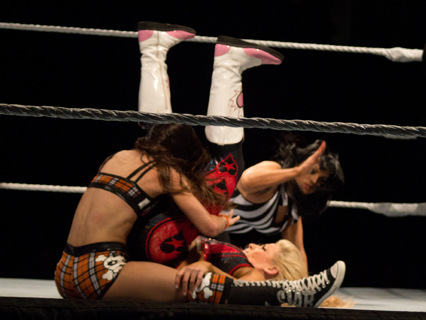 AJ performing a roll-up on Natalya.